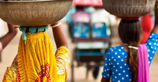 ladies carrying food on their heads - India