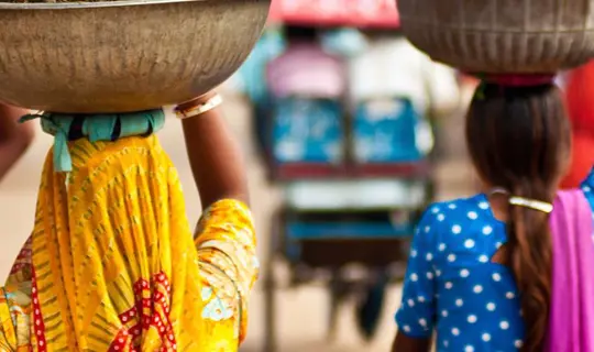 ladies carrying food on their heads - India